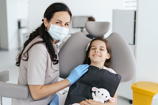 Little beautiful girl at the dentist looking at the camera and smiling