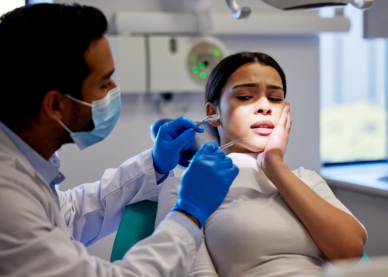 female patient with dentist for dental emergency