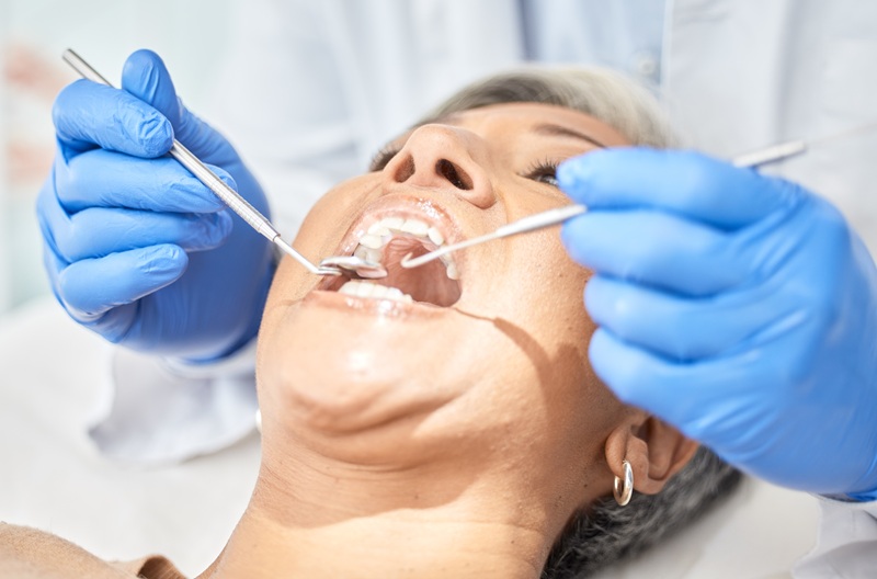 Woman, mouth and dentist hands with tools, medical and dental procedure, healthcare and closeup. Or.