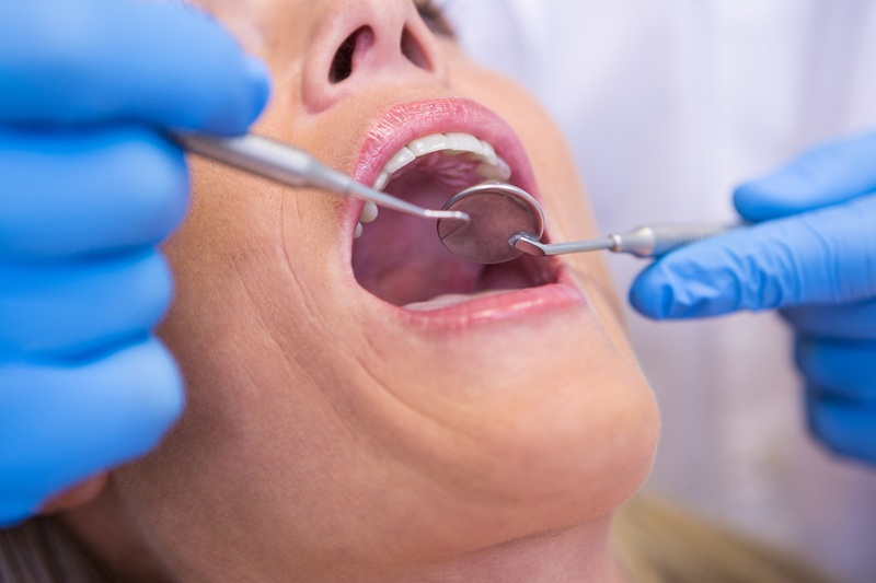 dentist checking a female patient for a dental abscess
