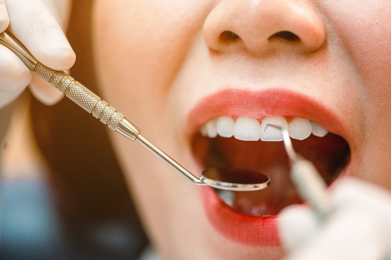 Dentist examining teeth patients in clinic for better dental health and a bright smile.Dentist checking teeth with tools.Dentist tools and equipment.